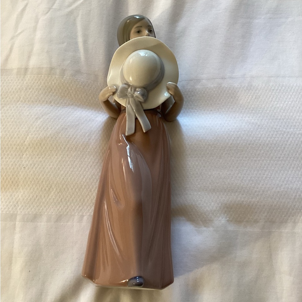 Lladro Porcelain’s Lladro “Bashful Girl with Hat Figurine